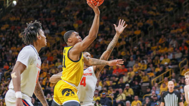 Iowa's Tony Perkins (11) releases a shot during a game against Illinois on March 10, 2024 at Carver-Hawkeye Arena in Iowa City, Iowa. (Rob Howe/HN)